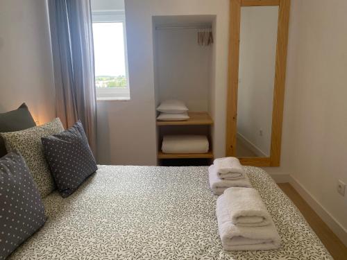 a bedroom with a bed with towels on it at Casa do Marko in Estremoz