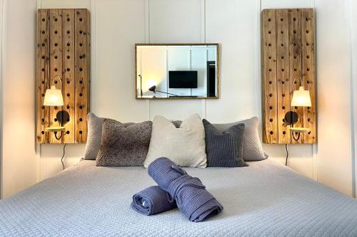 a bedroom with a bed with a mirror on the wall at Fireside Inn & Hostel in Breckenridge