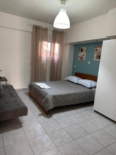 a bedroom with a bed and a couch in it at La kaza studio in Ofrínion