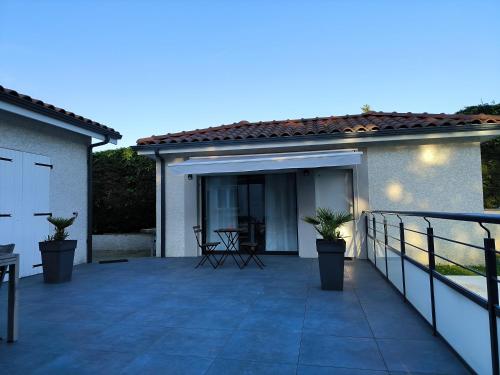 a patio with a table and chairs on it at Petit nid douillet in Reventin-Vaugris