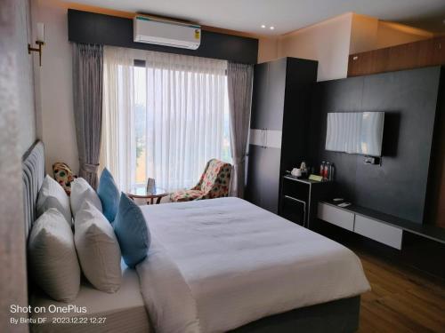 a hotel room with a bed and a window at Kaara Gurgaon in Gurgaon