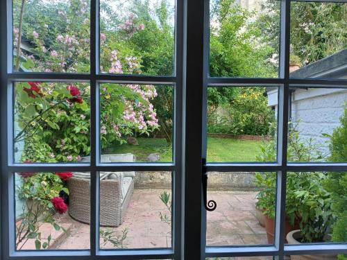 a view through a window of a garden at Michaelmas Cottage Upavon in Upavon