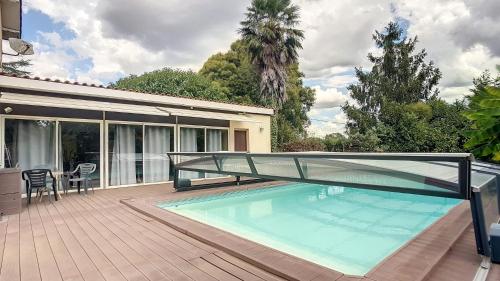 - une piscine avec un pont en verre sur une terrasse dans l'établissement La Vie Autrement - Maison à la campagne, à Claracq