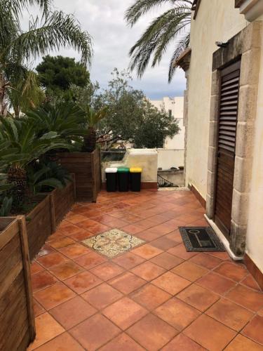a patio with plants and trash cans on a house at Apulia House in Bisceglie