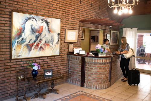 a woman standing at a cash register in a store at Don Numas Posada & Spa in San Lorenzo