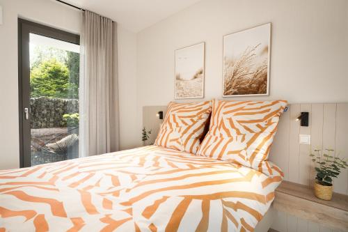 a zebra print bed in a bedroom with a window at Stay Boardinghouse in Würselen