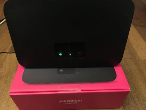 a electronic device sitting on top of a pink box at Townhouse with garden, terrace & balcony in Berlin