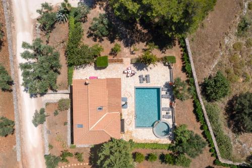 an overhead view of a building with a swimming pool at Aresti Mountain Resort in Agios Leon