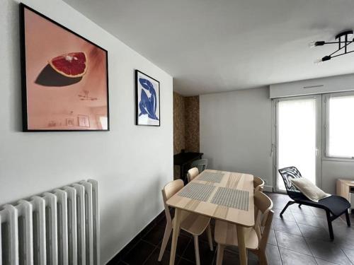- un salon avec une table, des chaises et un radiateur dans l'établissement Beau T3 refais à neuf hyper centre de Lorient !, à Lorient