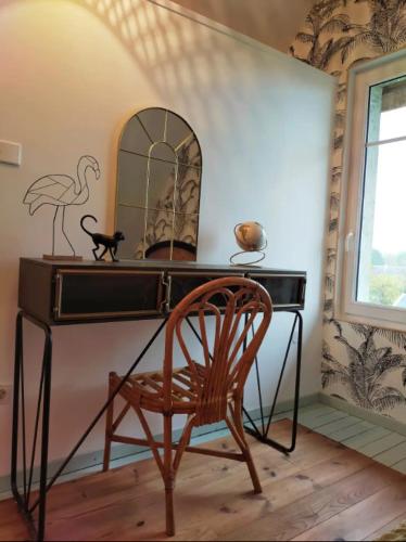 a desk with a chair and a mirror at Gite Flora in Salency