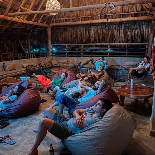 a group of people sitting on bean bags in a room at Casa Mambo Salinas in Santa Veronica
