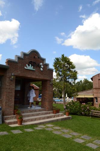 a woman is walking into a brick building at Don Numas Posada & Spa in San Lorenzo