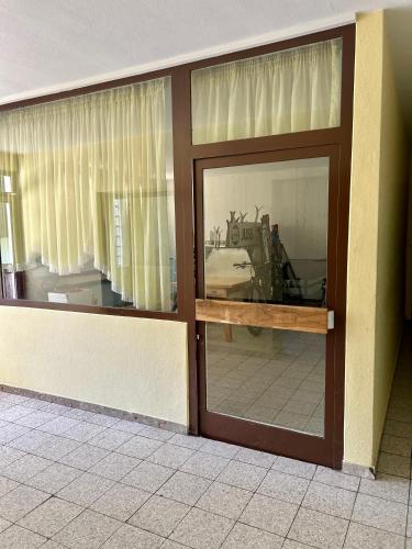 a sliding glass door in a building with a room at M3-Alpendomizil in Mühlbach am Hochkönig
