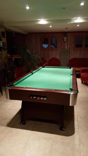 a pool table in a living room with afits at LOGIS DE NANO in Gratens