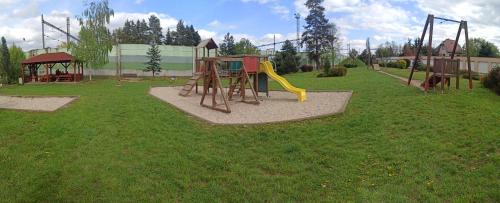 a playground with a slide in a park at Apartmány Volavka 2 in Planá nad Lužnicí