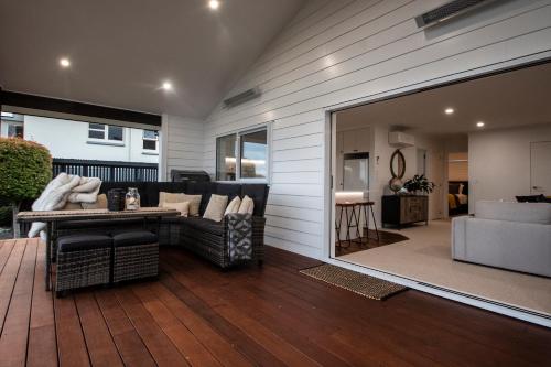 ein Wohnzimmer mit Sofa und Tisch in der Unterkunft Clareview Cottage in Rotorua