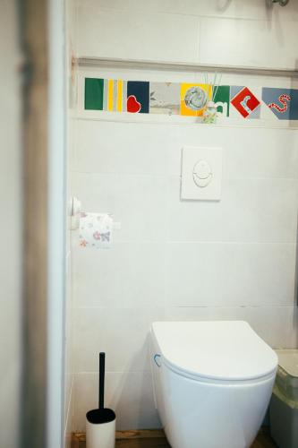 a bathroom with a white toilet in a room at ArtRock Studio in Radovljica