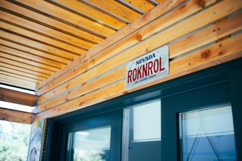 a sign on the side of a wooden house at ArtRock Studio in Radovljica