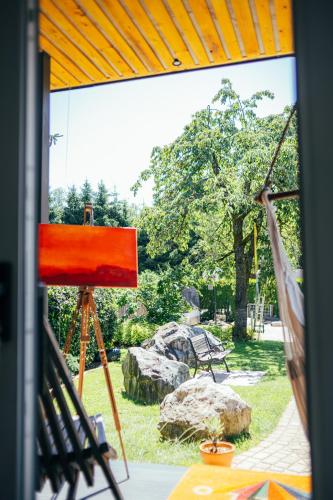 a view from a window of a hammock in a park at ArtRock Studio in Radovljica