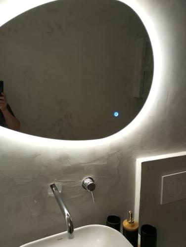 a person taking a picture of a bathroom mirror at Διαμερίσματα CANNA in Samos