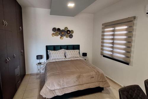 a bedroom with a large bed and a window at Διαμερίσματα CANNA in Samos