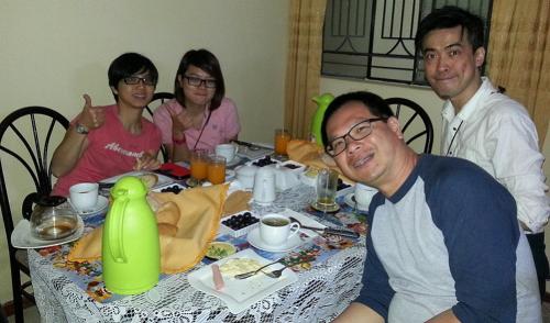 a group of people sitting around a table at Anccalla Inn Guesthouse in Nazca
