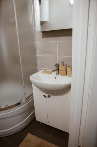 a white bathroom with a sink and a toilet at Pablo Apartment in Cesis in Cēsis