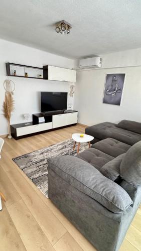 a living room with a couch and a tv at Aly Home in Castellón de la Plana