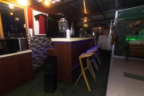 a bar in a restaurant with purple stools at Todo incluido terraza de lujo con jacuzzi in Arequipa