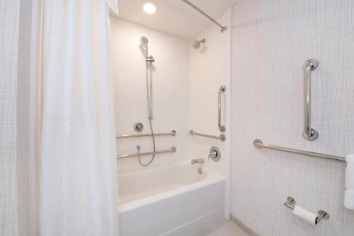 a white bathroom with a tub and a shower at Hilton Garden Inn Columbia Downtown in Columbia