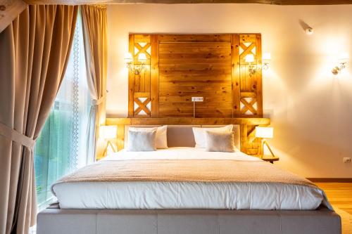 a bedroom with a large bed and a window at Casa Baciu Colacu in Fundu Moldovei