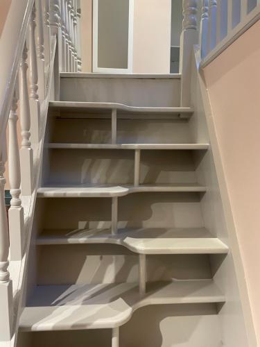 a stairwell with white steps and blue railing at Croagh Patrick Studio in Murrisk