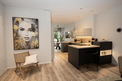 a kitchen with a painting of a woman on the wall at Stay Boardinghouse in Würselen