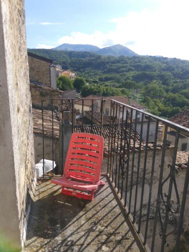a red chair sitting on top of a balcony at Bnb Peter Pan in San Martino dʼAgri