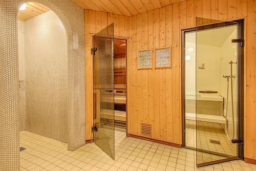 a bathroom with a shower and a glass door at Haus Hubertus in Galtür