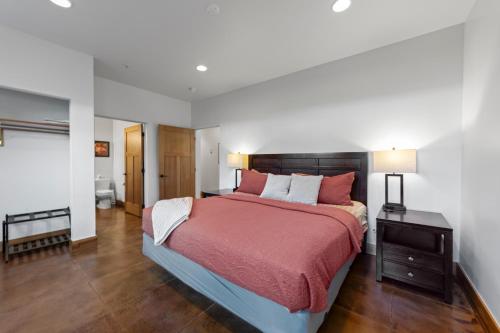 a bedroom with a large bed with a red blanket at 57 Robber's Roost in Moab