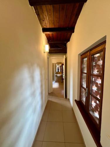 a hallway of a house with a ceiling and a window at Borgo del 1700- Le Scuderie- trilocale in Travedona