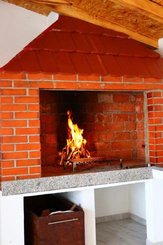 a brick oven with a fire in it at Villa Crystal in Bihać