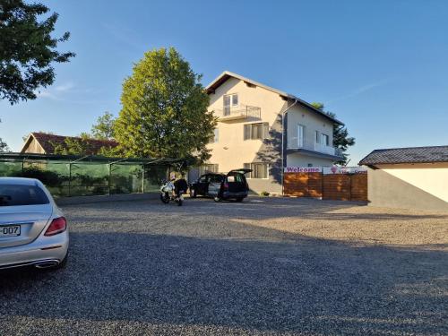a car parked in a parking lot in front of a house at Villa Crystal in Bihać