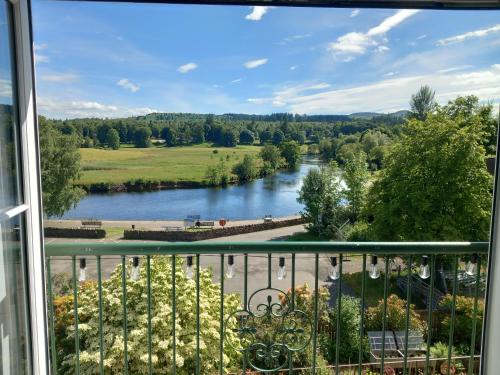 a view of a river from a balcony at Idyllic Waterside Penthouse in Callander
