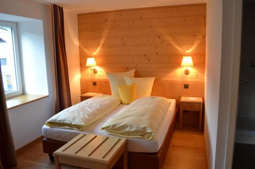 a small bedroom with two beds and a window at Hotel-Restaurant Bellevue in Flims