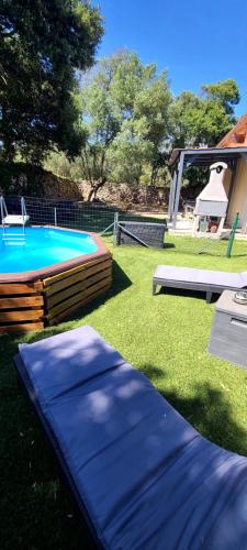 a backyard with a large blue pool and a grill at villa Paty in Bonifacio