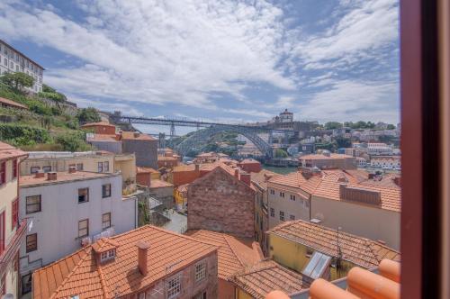 a view of a city with a bridge in the background at VC Heritage Ribeira Porto in Porto