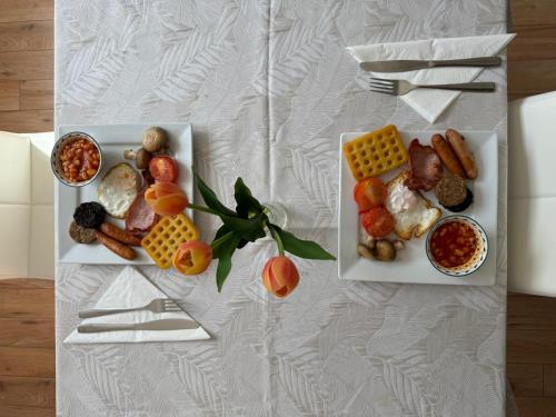 two white plates of food on a table at Maya's Lodge in Dublin
