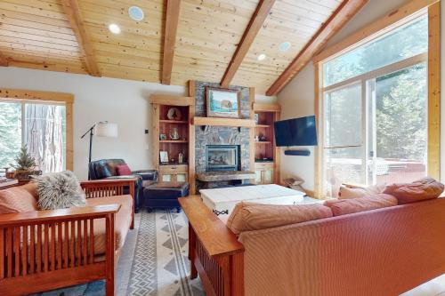 a living room with two couches and a large window at West Shore Retreat in Tahoma