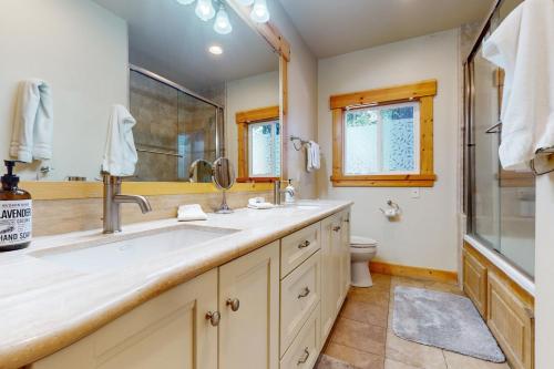 a bathroom with a sink and a shower and a toilet at West Shore Retreat in Tahoma