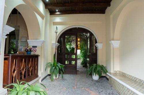 an entry to a house with a door and plants at Casa Noble Hotel in Antigua Guatemala