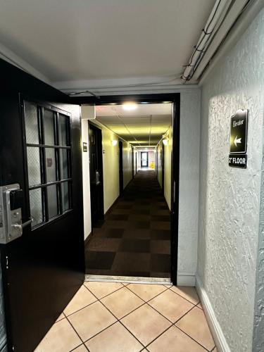 a hallway leading to a room with a sign on the wall at Motel 6-Hazelwood, MO in Hazelwood