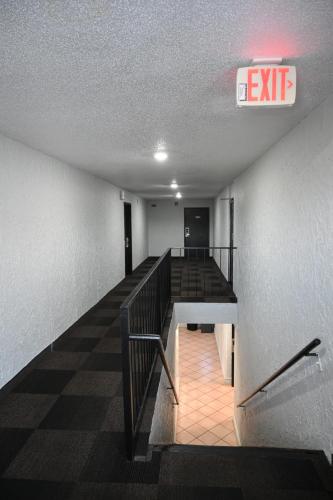 an exit sign in a building with a staircase at Motel 6-Hazelwood, MO in Hazelwood