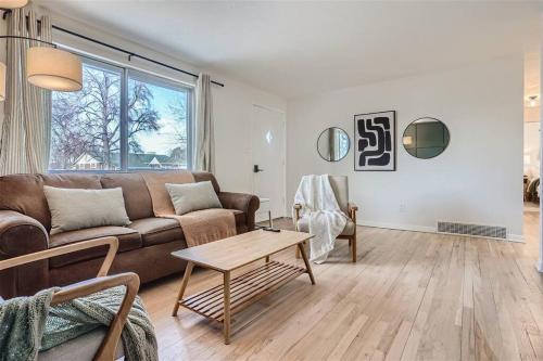 a living room with a couch and a table at Serene, Spacious Home in Quiet Neighborhood with Fenced Yard in Aurora